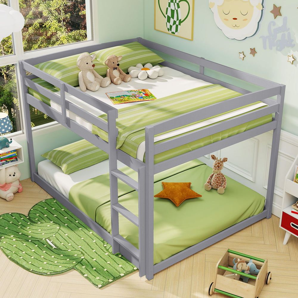 Gray full over full low-to-ground bunk bed with solid wood frame, guardrails, and integrated ladder for kids' safety.