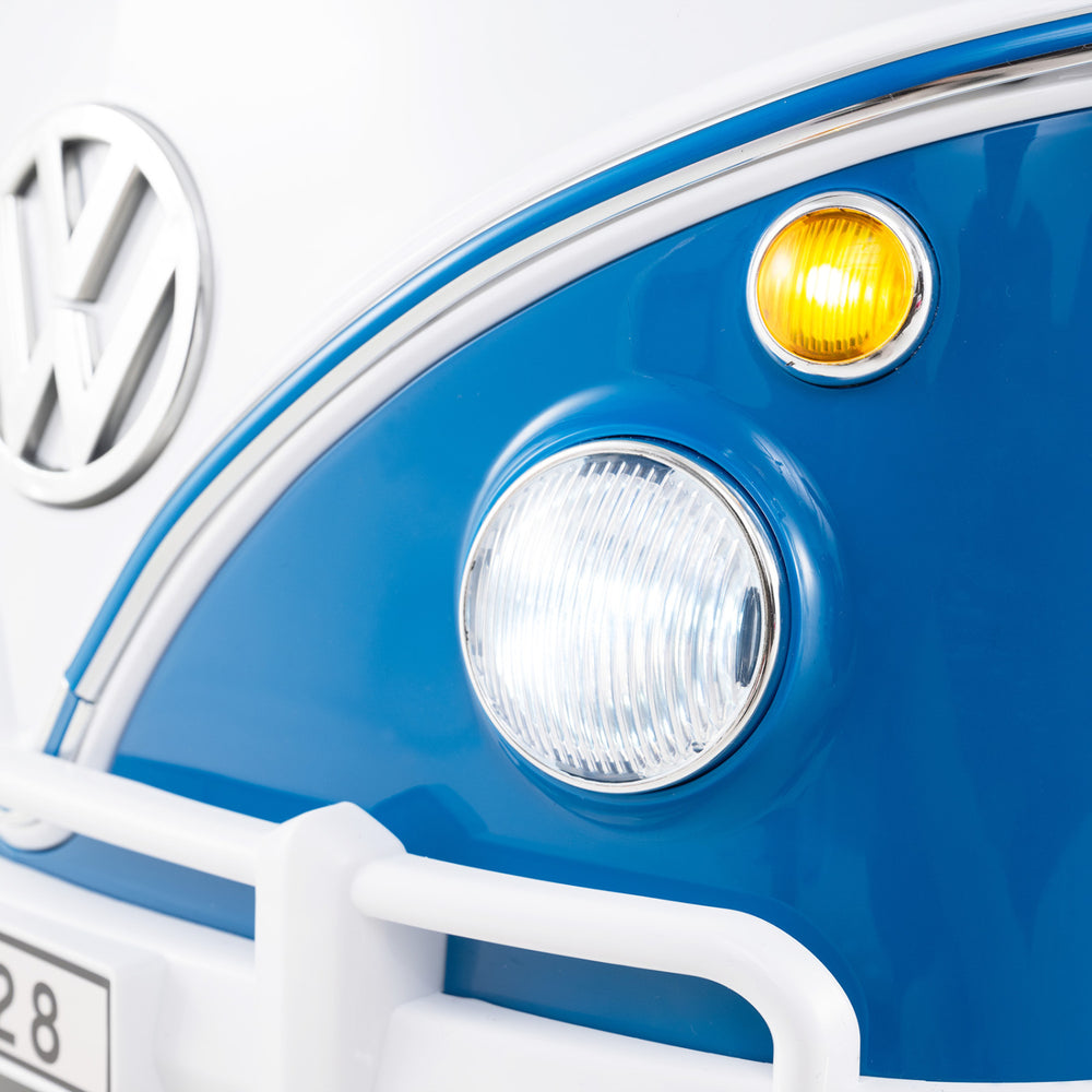Close-up of the blue Volkswagen ride-on bus headlight and turn signal, featuring LED lights for kids' fun.