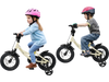 Kids riding 12-inch sport bicycles with removable training wheels, featuring adjustable seats and dual brake methods.