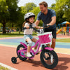 Child riding a pink 12-inch bike with training wheels, featuring a front basket and adjustable seat, perfect for ages.