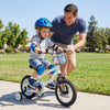 Child riding a 12-inch kids bike with training wheels, featuring bright monster graphics and adjustable seat for ages.
