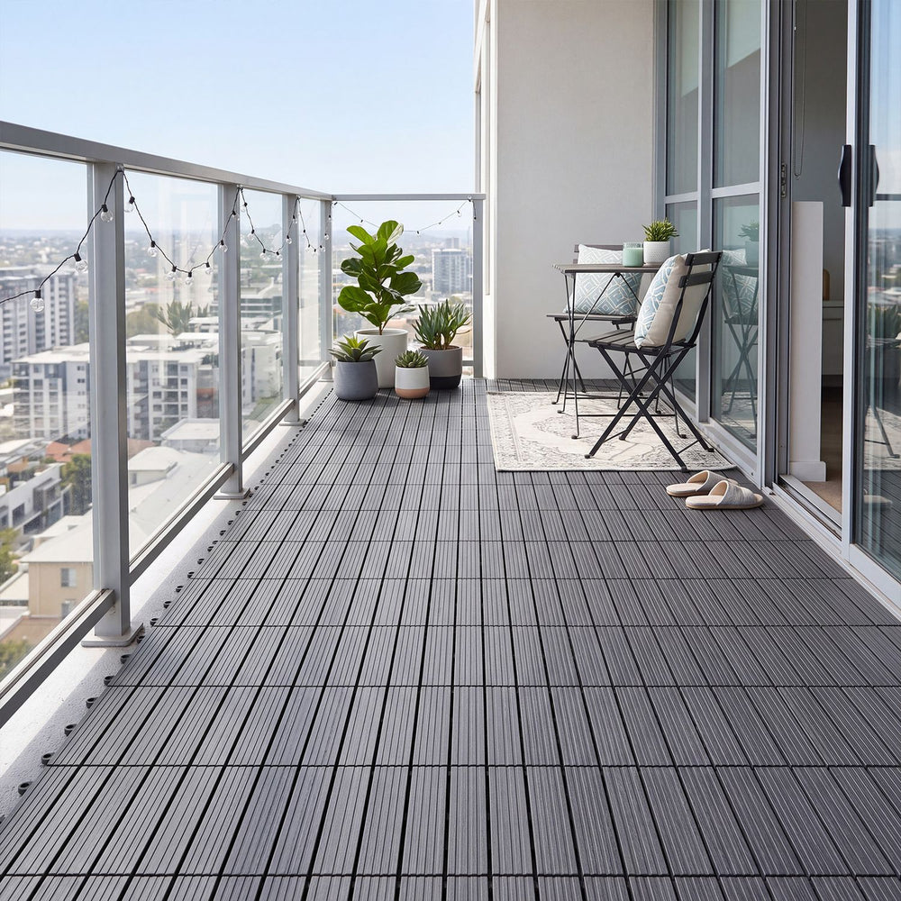 Gray 12” x 12” waterproof PP plastic interlocking deck tiles arranged on a balcony for stylish outdoor flooring.