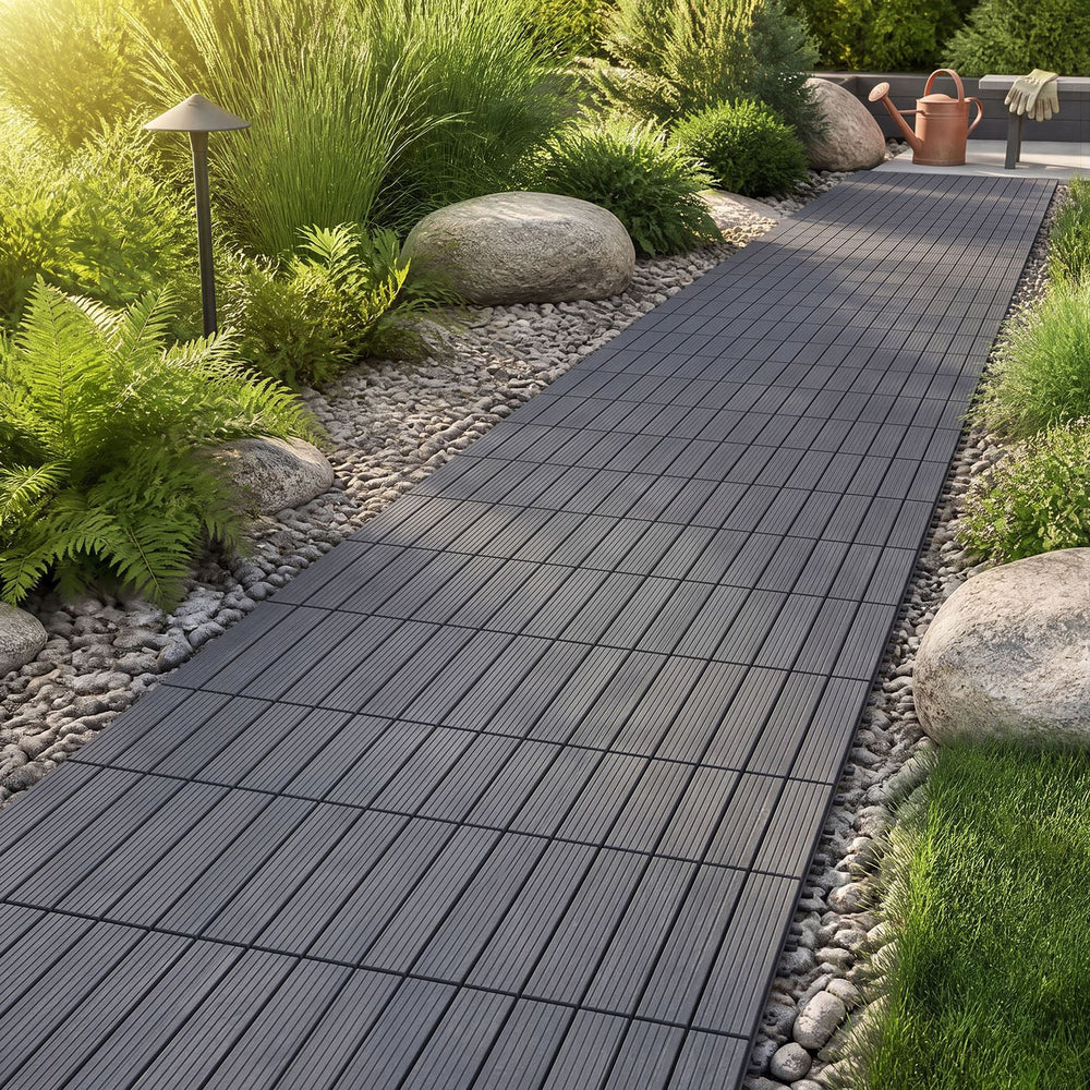 Gray 12” x 12” waterproof PP plastic interlocking deck tiles arranged on a garden pathway for easy outdoor installation.