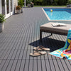 Gray 12” x 12” waterproof PP plastic interlocking deck tiles arranged on a patio, ideal for quick installation and maintenance.