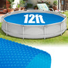 12ft round above ground swimming pool with a blue bubble cover, designed to retain heat and reduce debris contamination.