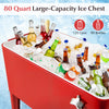 Red portable patio cooler with 80-quart capacity, filled with drinks and ice, featuring a bottom shelf and bottle.