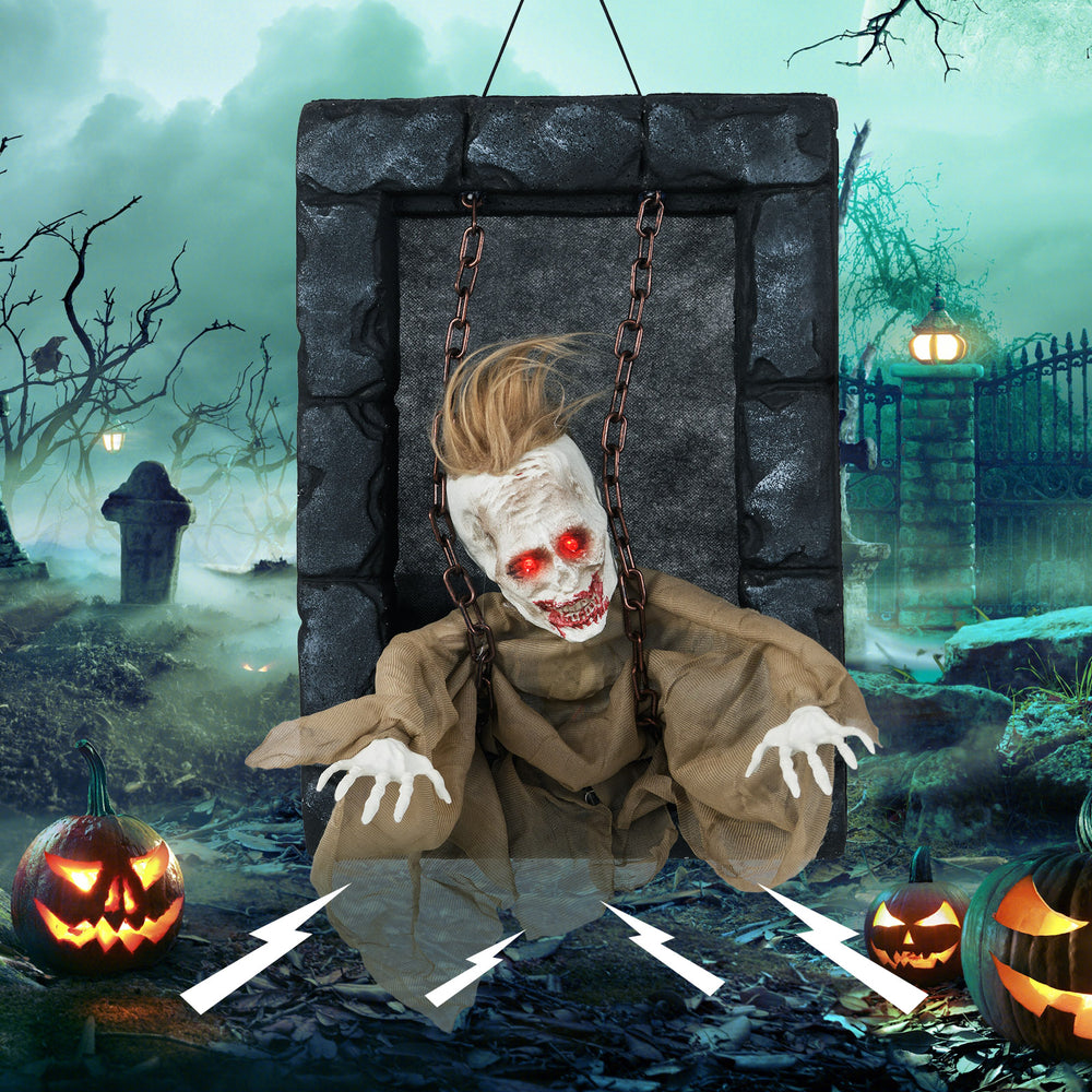 Creepy Halloween hanging animated zombie prisoner with moving features and glowing red eyes, perfect for frightful.