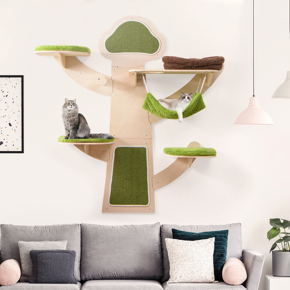 Wall-mounted cat tower with green padded platforms and ultra-soft bed, perfect for play and relaxation in small spaces.