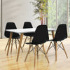 Mid-century modern dining set featuring two black DSW chairs with wood legs, ideal for stylish dining room decor.