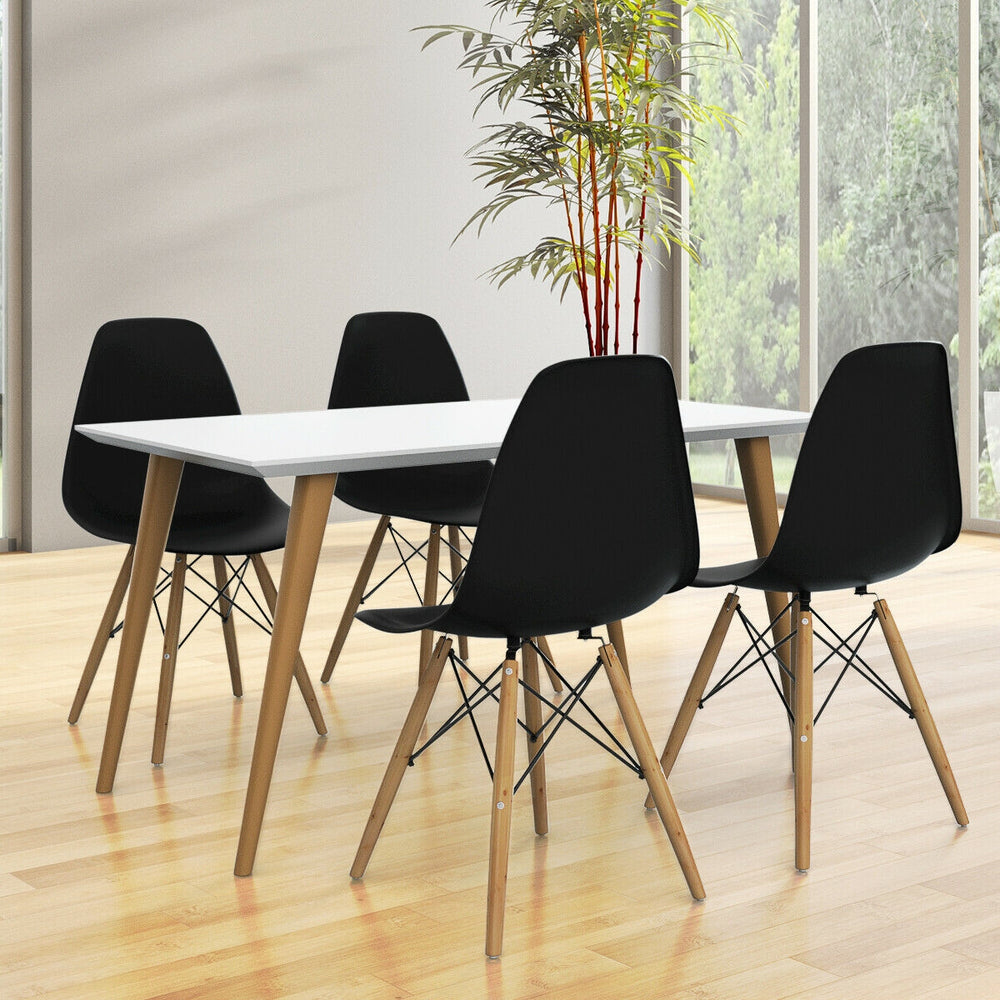 Mid-century modern dining set featuring two black DSW chairs with wood legs, ideal for stylish dining room decor.