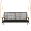 Spacious 2-person patio wicker hanging swing chair with black cushion and acacia wood armrests for outdoor relaxation.