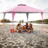 Pop-up gazebo in pink, 13 x 13 ft, providing shade for outdoor gatherings at the beach with friends.