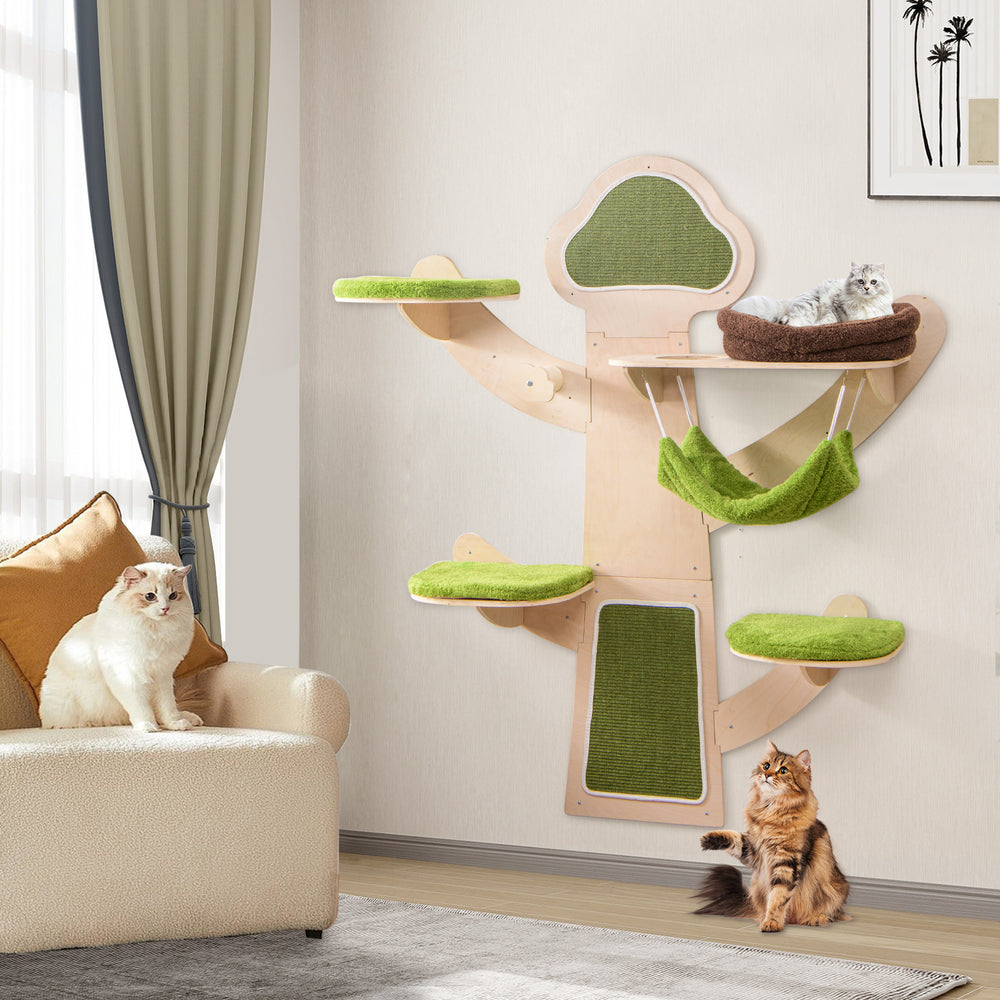 Wall-mounted cat tower with green padded platforms and hammock, designed for play and relaxation in small spaces.
