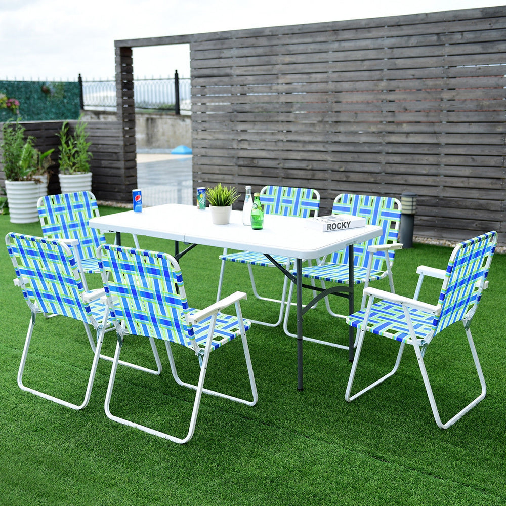 Six blue folding beach chairs with a solid steel frame arranged around a table on a lawn, perfect for outdoor.