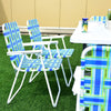 Folding beach chairs in blue webbing with a steel frame, perfect for camping and outdoor gatherings.