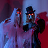 Standing Halloween animatronic bride and groom with glowing red eyes, perfect for haunted house decoration.