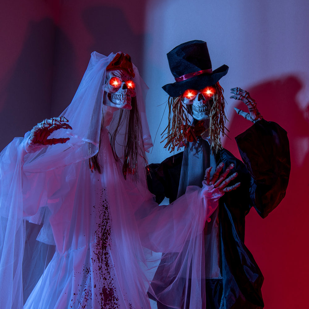 Standing Halloween animatronic bride and groom with glowing red eyes, perfect for haunted house decoration.