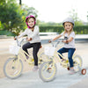 Two girls riding 14-inch kids bikes with adjustable handlebars, training wheels, and removable storage baskets.