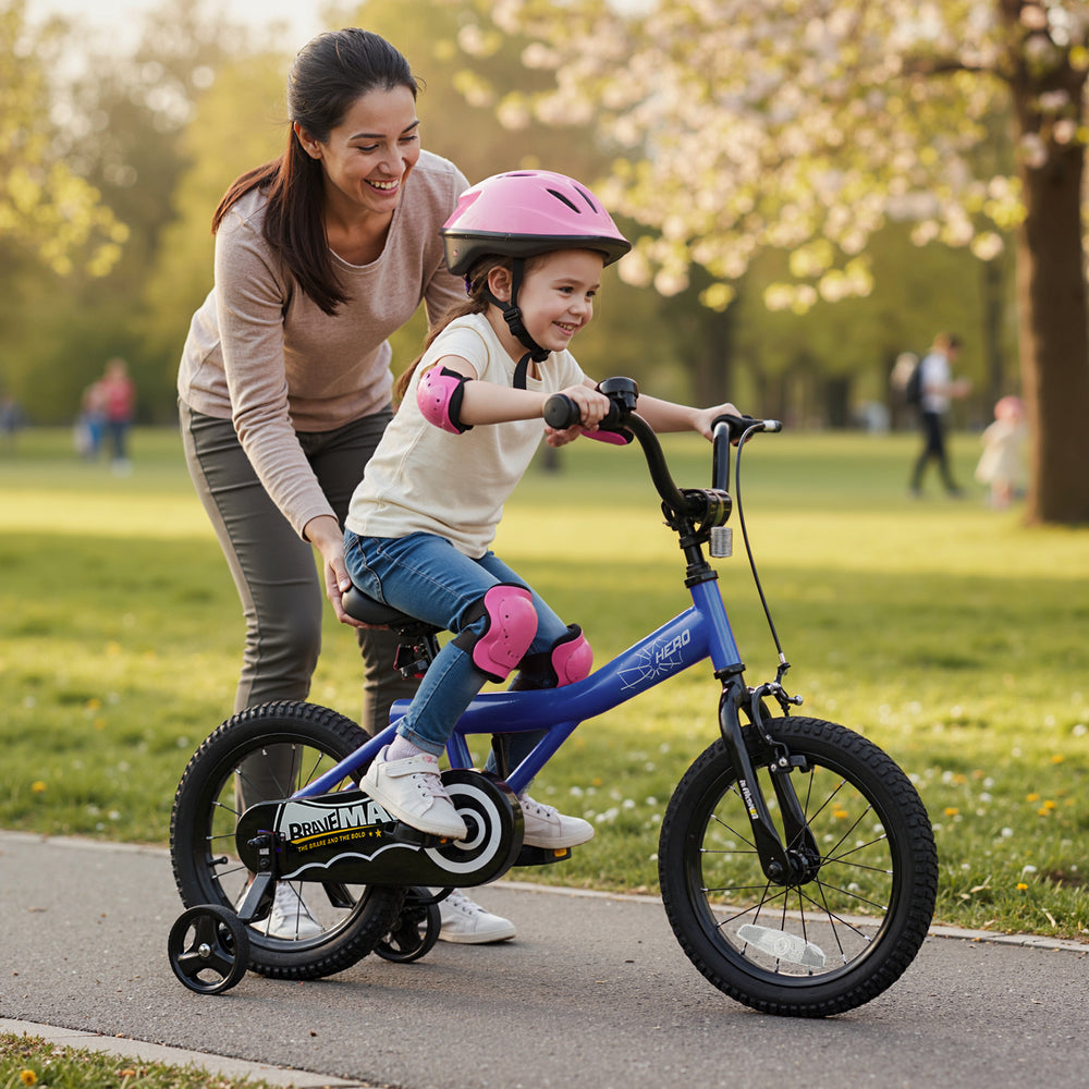 Child riding a 14-inch navy bike with removable training wheels, featuring adjustable seat and handbrakes for safety.