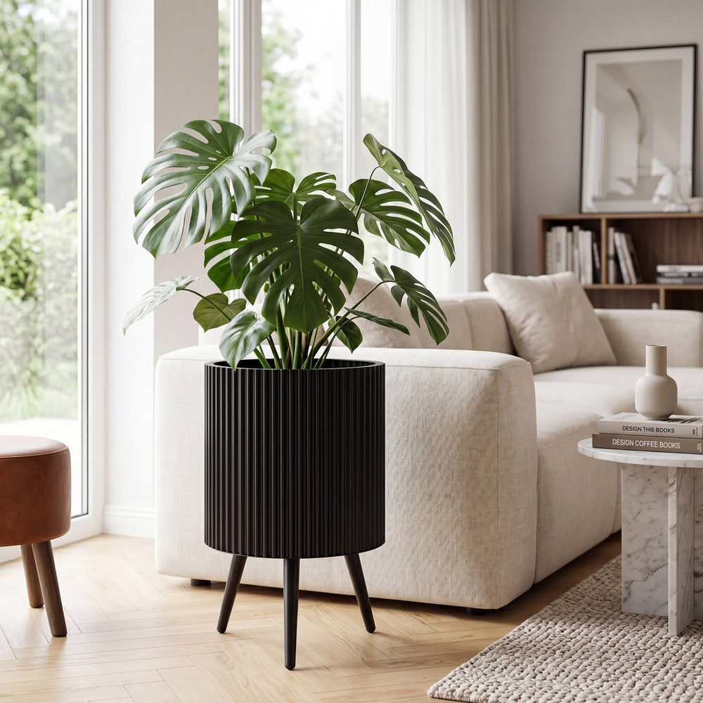 Aesthetic 14-inch fluted metal plant pot with tapered legs, ideal for indoor and outdoor use to enhance plant growth.