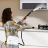 Woman using a 1500W portable steam cleaner with a 34 oz water tank to clean kitchen surfaces effectively.