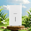 150 pints dehumidifier in white with LED display, placed in a natural setting for effective humidity control.