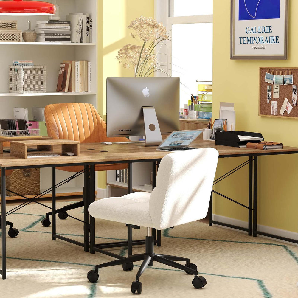 L-shaped desk with monitor shelf and adjustable Ergo Comfort chairs in a stylish office setup for efficient workspace.