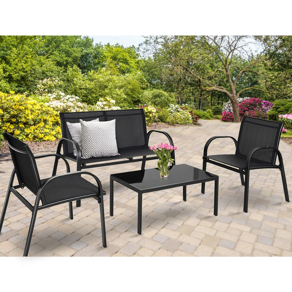 4-piece black patio furniture set featuring a loveseat, two single sofas, and a glass top coffee table for outdoor.