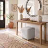 Gray square storage ottoman with solid rubber wood legs, featuring a plush cushioned top for versatile seating and storage.