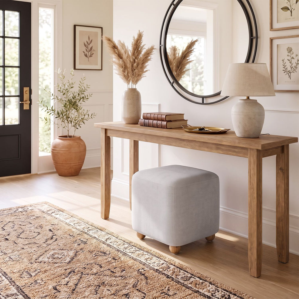 Gray square storage ottoman with solid rubber wood legs, featuring a plush cushioned top for versatile seating and storage.