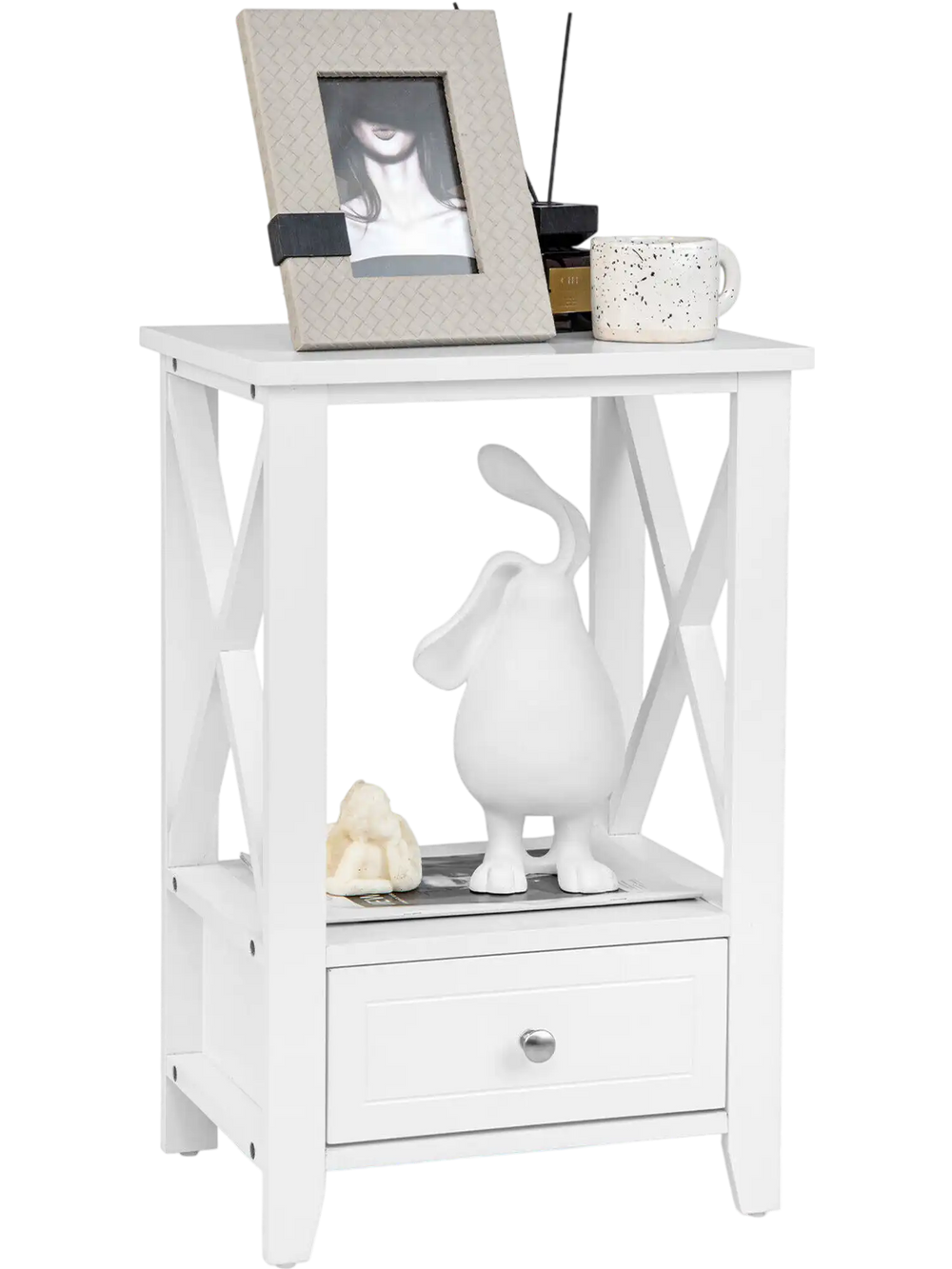 White 2-tier nightstand with storage drawer, open shelf, and X-shaped design for versatile use in any room.