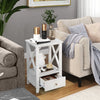 White 2-tier nightstand with storage drawer, open shelf, and X-shaped design, perfect for living room or bedroom use.