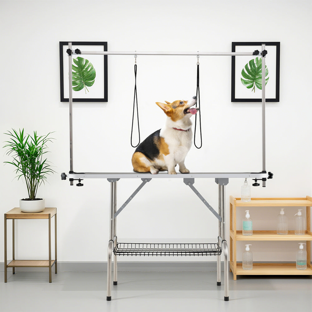 Foldable dog grooming table with height adjustable arms, featuring a non-slip waterproof surface for pet care.