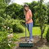 Manual lawn aerator with 21-inch roller in use, featuring comfortable non-slip handle for effortless soil aeration.