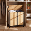 Two-section natural bamboo laundry hamper with lid and lockable wheels for easy sorting and secure placement.
