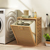 Natural bamboo tilt-out laundry hamper with removable fabric bin, showcasing a side view of the slatted design and.