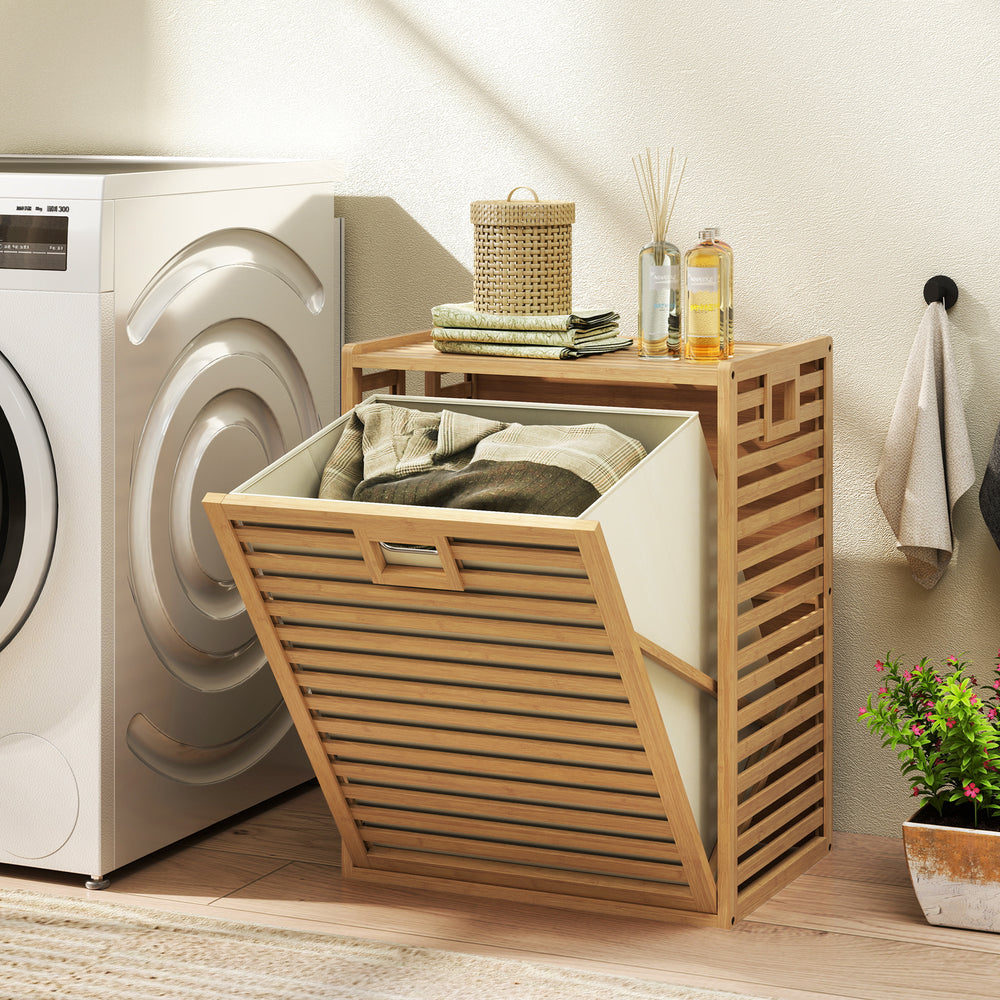 Natural bamboo tilt-out laundry hamper with removable fabric bin, showcasing a side view of the slatted design and.