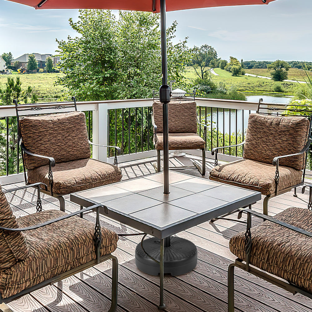 Heavy-duty round umbrella base stand with a fillable reservoir, designed for stability in outdoor settings like patios.