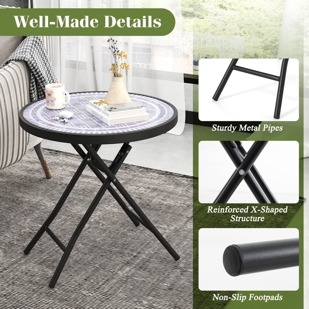 Round gray folding side table with tempered glass top and reinforced X-shaped metal frame for indoor and outdoor use.
