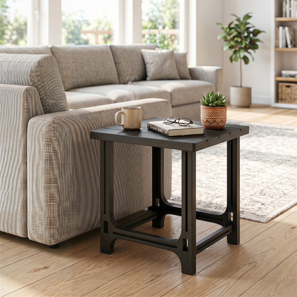 Black 18-inch outdoor Adirondack side table features a slatted surface and sturdy frame, ideal for poolside use.