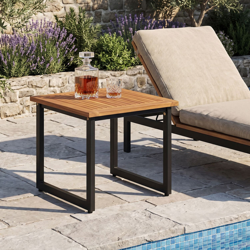 Square acacia wood patio side table with slatted top and black powder-coated metal frame, ideal for outdoor use.