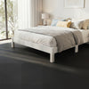 Interlocking black EVA foam floor tiles provide comfort and shock absorption, ideal for home gyms and living spaces.
