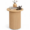 Round fluted side table in natural finish features a sturdy pedestal design and non-slip foot pads for small spaces.