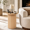 Round fluted side table in natural finish, featuring a sturdy pedestal design and non-slip foot pads for small spaces.