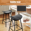 Set of 2 black swivel barstools with faux leather saddle seats and footrests, ideal for kitchen islands and home bars.