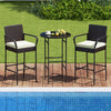 Outdoor bar set featuring two cushioned chairs and a round table, perfect for backyard or poolside relaxation.