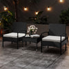 Two black rattan bistro chairs with beige cushions and a matching coffee table, perfect for outdoor patio relaxation.