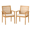 Set of 2 outdoor patio dining chairs in acacia wood with removable beige cushions and slatted backrest for comfort.