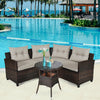 Outdoor wicker sofa set with soft cushions and coffee table, perfect for poolside relaxation and garden gatherings.