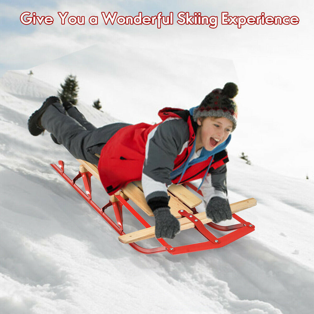 Kids wooden snow sled with metal runners and steering bar, 54 inches long, designed for smooth sliding in the snow.